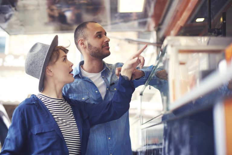 Young couple buying food on the street